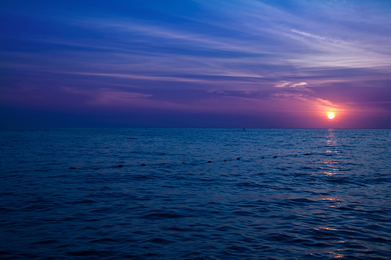 Sunset over crystal blue ocean