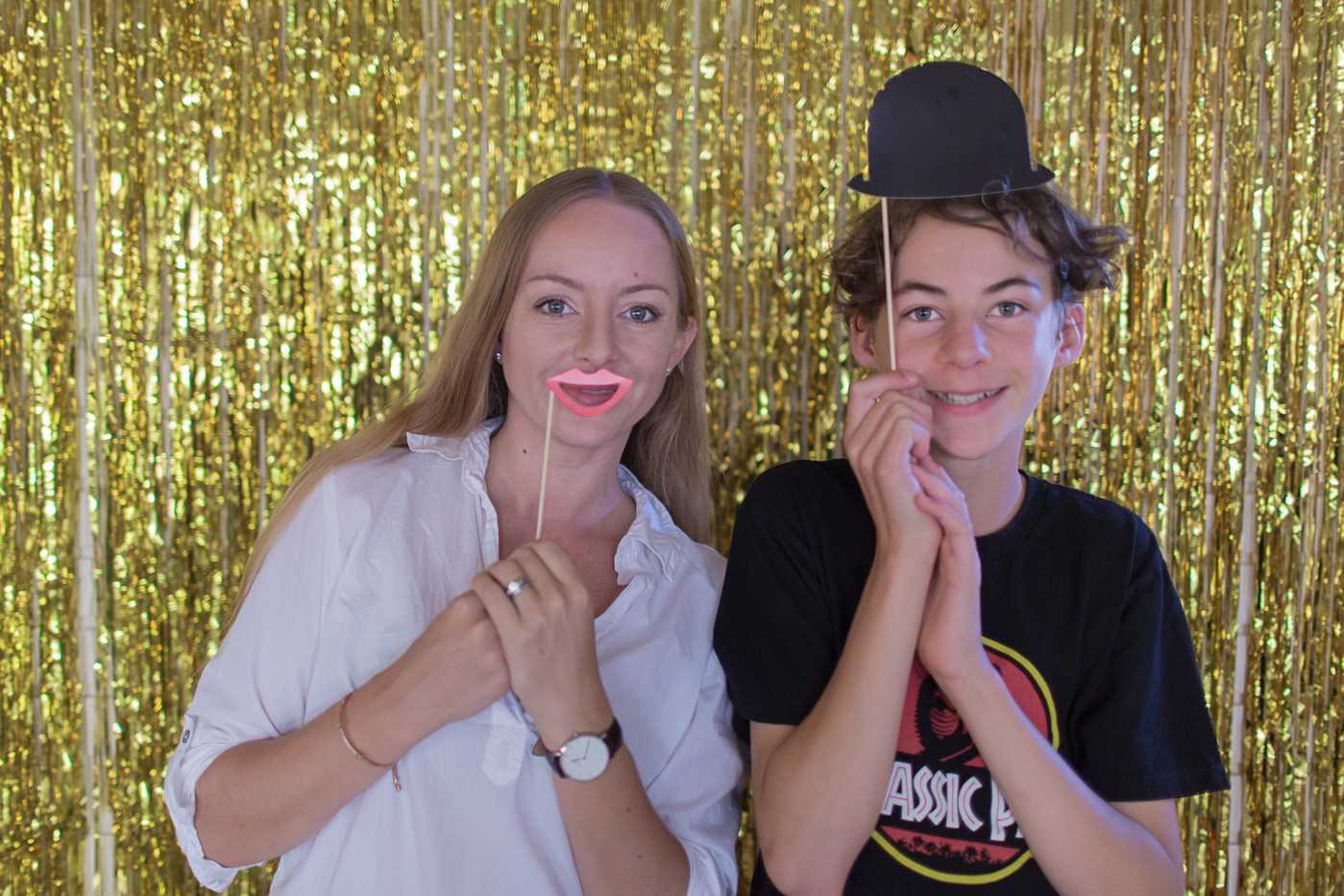 Gold foil photo backdrop and props at movie-themed party