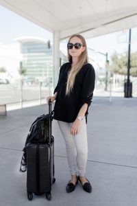 My go-to airport travel outfit, featuring Lou & Grey, Tumi, Everlane, & Coach.