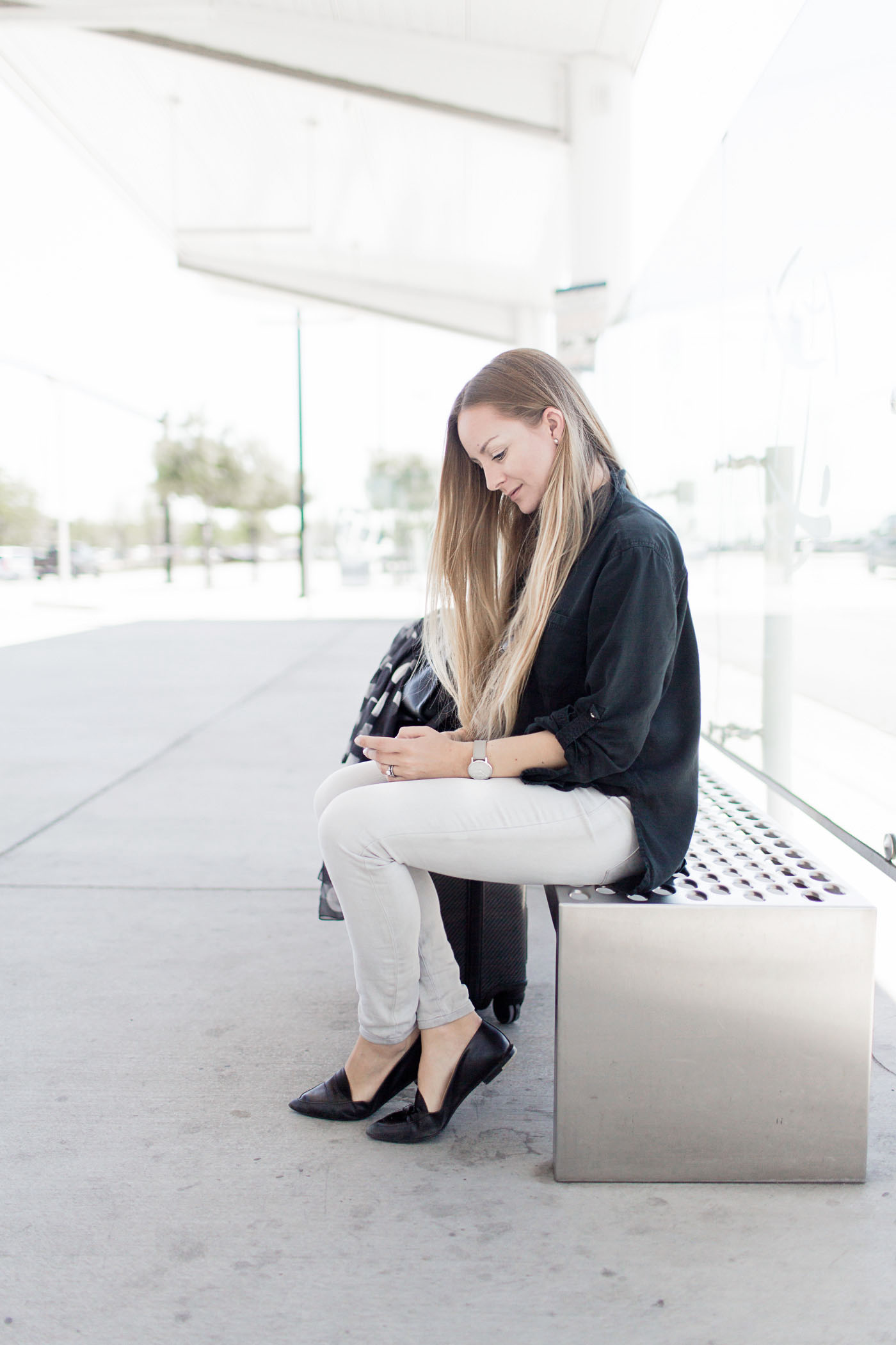 My go-to airport travel outfit, featuring Lou & Grey, Tumi, Everlane, & Coach.