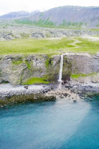 Waterfall into ocean in Western Iceland